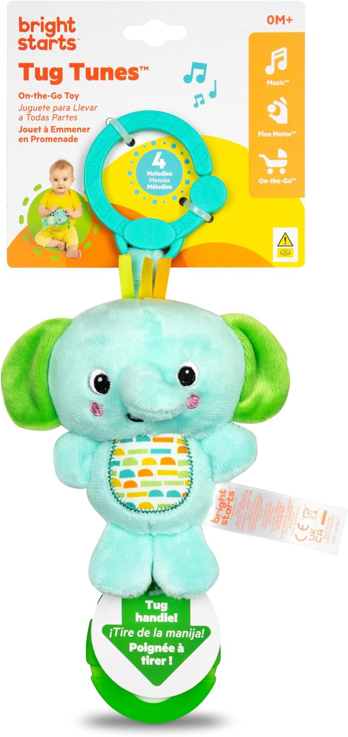 Bright Starts Tug Tunes on-the-go baby toy featuring a plush elephant rattle with a teal body, green ears and trunk, and a circular sound panel, shown with its retail packaging.