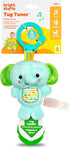 Bright Starts Tug Tunes on-the-go baby toy featuring a plush elephant rattle with a teal body, green ears and trunk, and a circular sound panel, shown with its retail packaging.